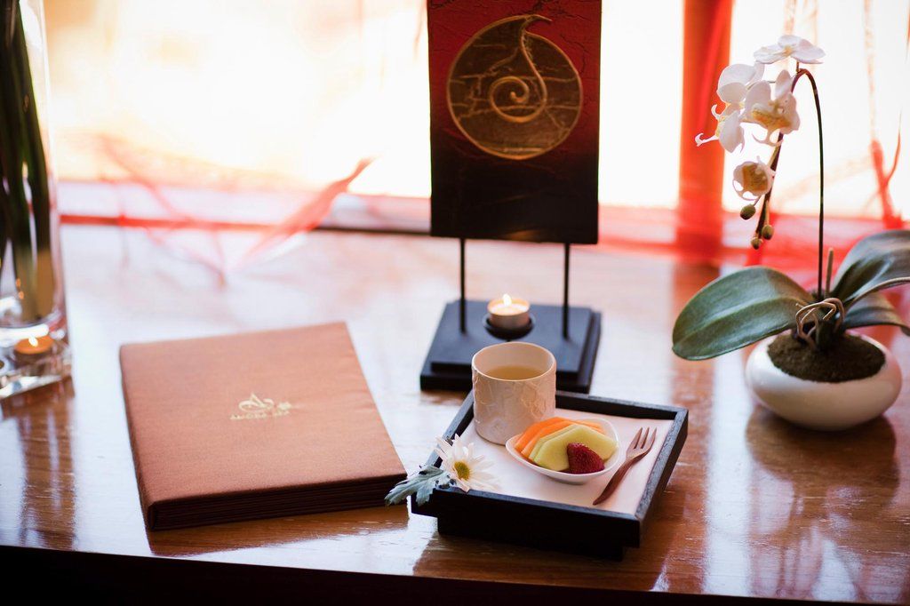 Amora Hotel Jamison Sydney Kültér fotó The photo shows a beautifully arranged setting featuring a small dessert display set on a tray. There is a small cup, possibly containing a drink or sauce, alongside a colorful dessert that appears to have layers. The tray is placed on a wooden table