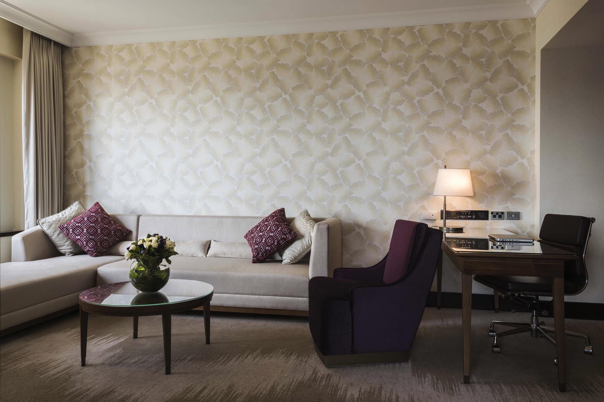 Amora Hotel Jamison Sydney Kültér fotó The photo shows a modern living space with a stylish design. There's a light-colored sofa with decorative pillows, a round coffee table in the center, and an armchair in a dark purple hue. To the side, there's a desk with a chair and a lamp, providin